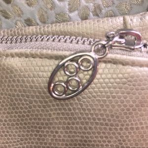 Metallic champagne colored wallet with teal inside, unbranded but adorable!